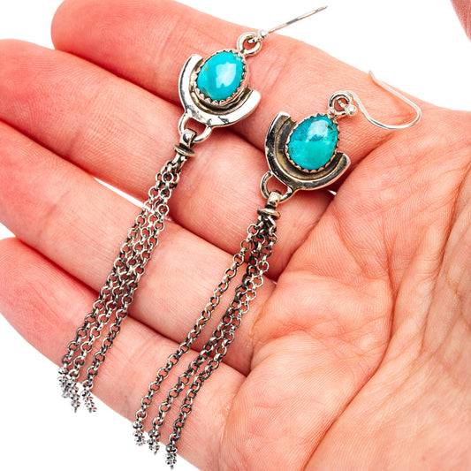 Turquoise teardrop earrings with horseshoe silver setting and dangling chain tassels