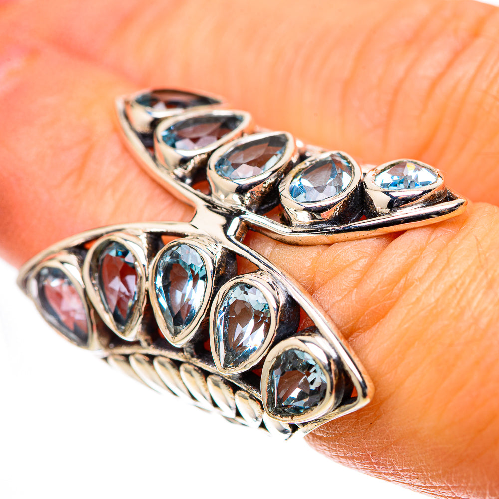 Sterling silver ring with large blue topaz oval stones, decorative prong setting
