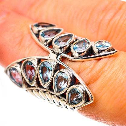 Sterling silver ring with large blue topaz oval stones, decorative prong setting