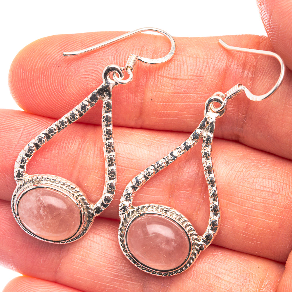 Sterling silver rose quartz drop earrings with pink oval gemstone and textured teardrop frame