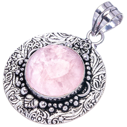 German silver rose quartz pendant with pink cabochon and detailed filigree border, hanging bail