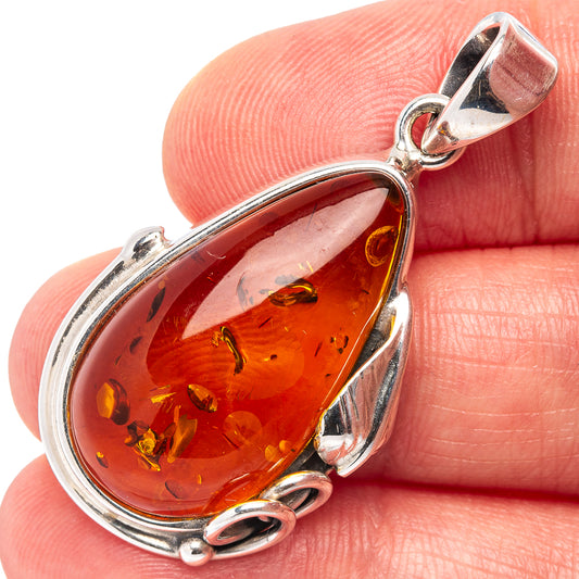 Oval amber pendant with warm honey resin in .925 sterling silver frame and bail loop