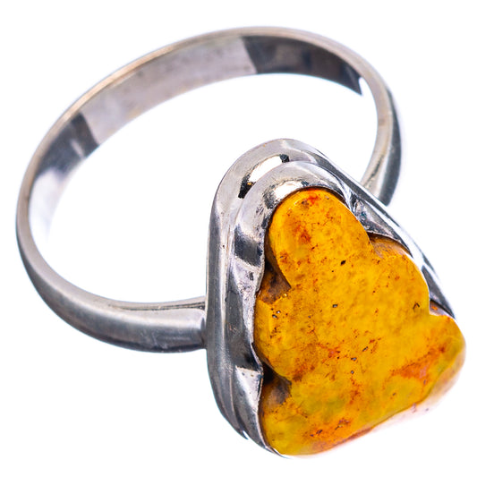 Sterling silver ring with large yellow stone in heart-shaped metal frame