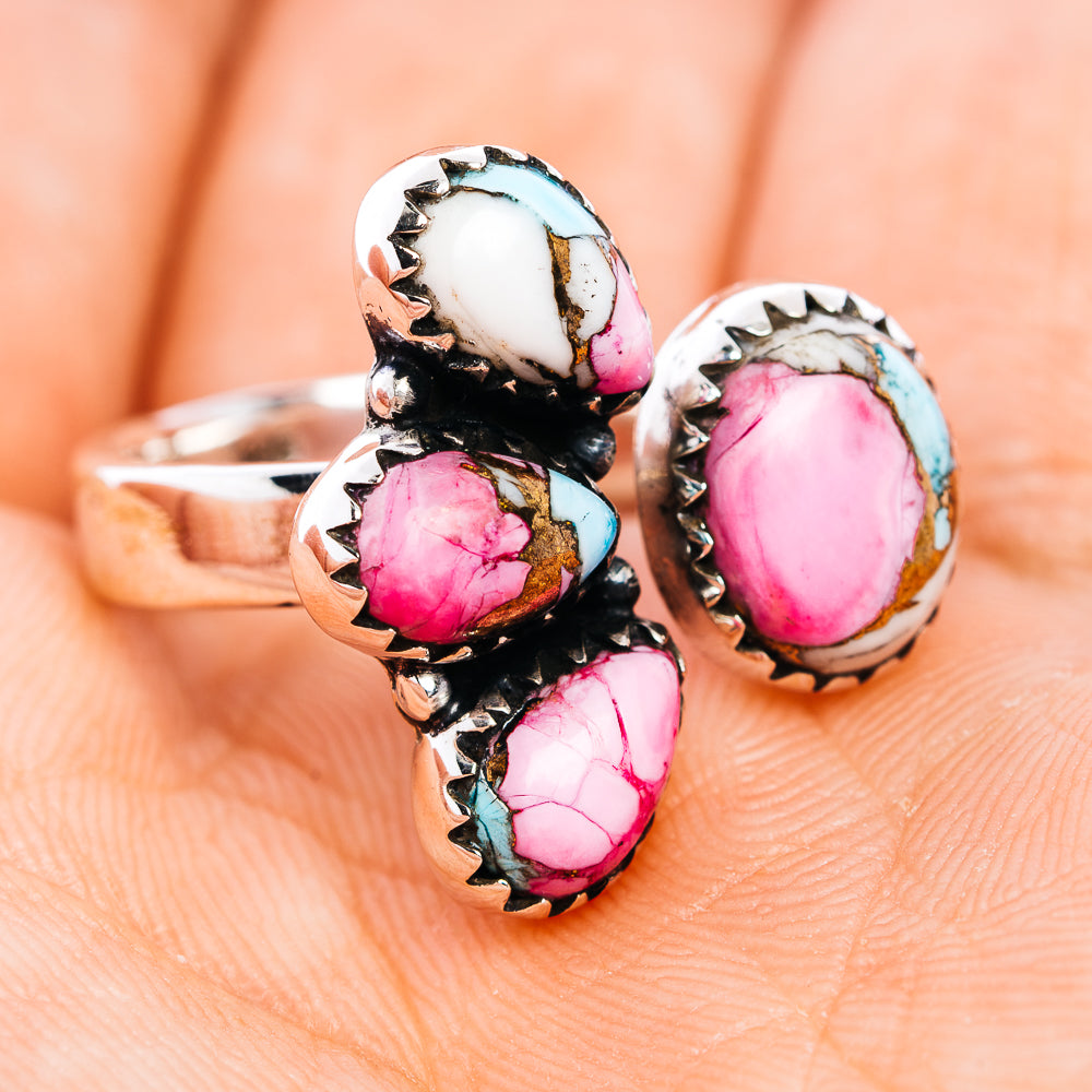 Adjustable sterling silver ring with pink oval center stone and turquoise side inlays