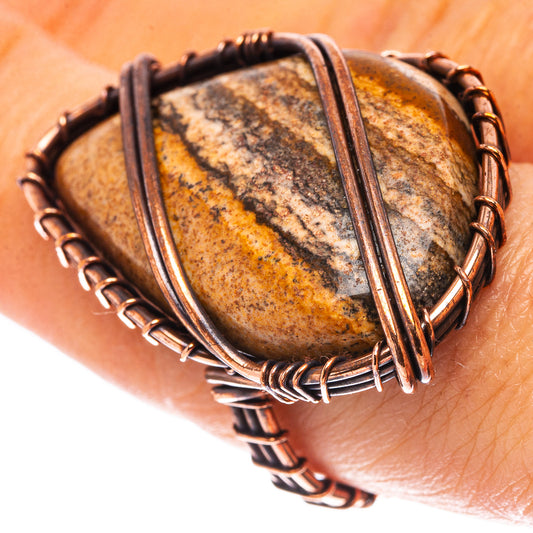Oxidized copper jasper ring on finger, oval stone with mottled tan and dark stripes