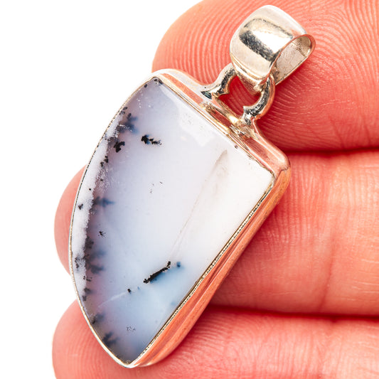 Sterling silver pendant with white dendritic opal and dark needle patterns in a bezel