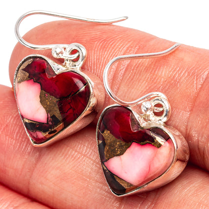 Heart-shaped sterling silver earrings with red-pink gemstone inlays, faceted sparkle