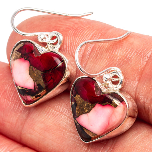 Heart-shaped sterling silver earrings with red-pink gemstone inlays, faceted sparkle