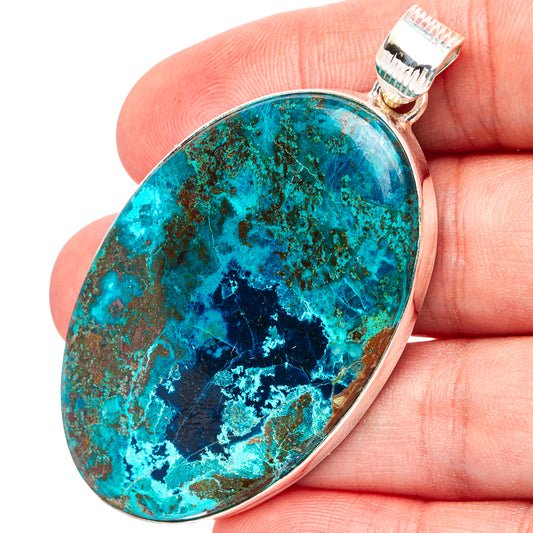 Oval blue-green Shattuckite pendant in silver bezel with loop bail, close-up