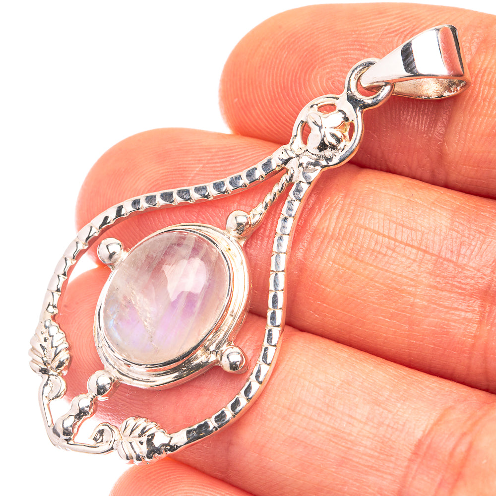 Sterling silver moonstone pendant with ornate filigree and oval iridescent stone