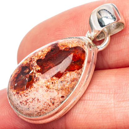 Close-up oval fire opal pendant with sterling silver bail and red orange mottled cabochon