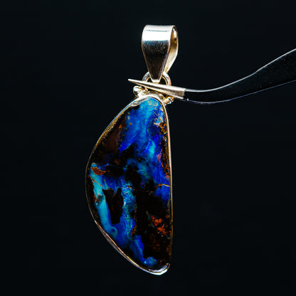Sterling silver boulder opal pendant with teardrop bezel, vivid blue stone