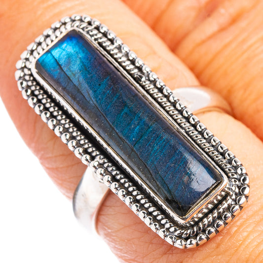 Sterling silver labradorite ring on finger, rectangular blue stone with gold flash, beaded edge