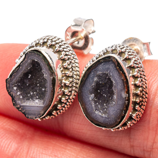 Close-up of oval druzy geode stud earrings in .925 sterling silver with rope border.