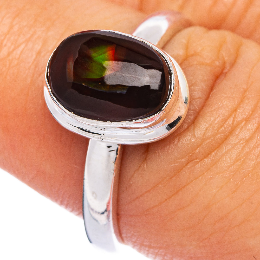 Sterling silver ring with dark oval agate and green-red iridescent flashes