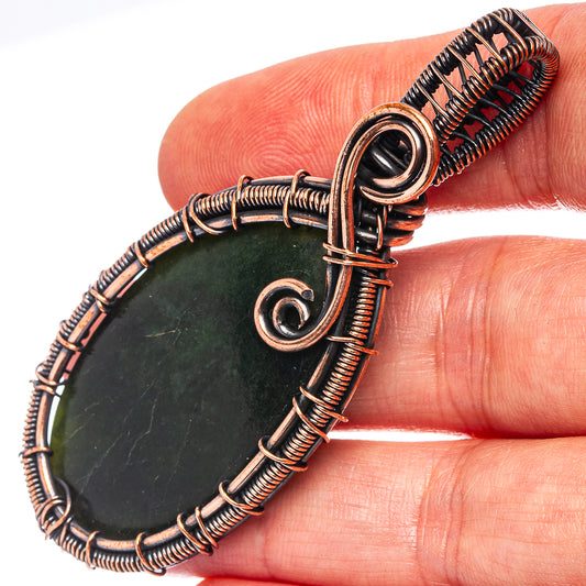 Nephrite jade wire-wrap pendant on oxidized copper, oval stone with spiral bail