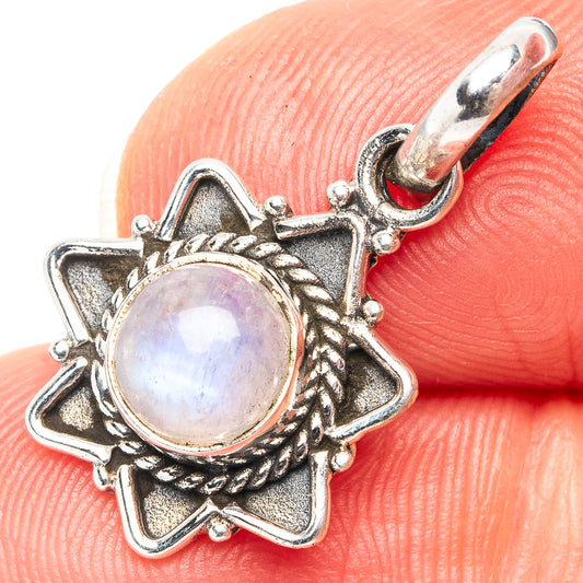 Sterling silver moonstone pendant with round iridescent stone and ornate star bezel