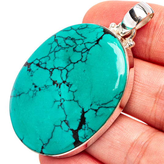 Turquoise teardrop pendant with black veining, silver bezel and bail