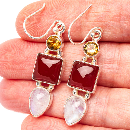 Sterling silver drop earrings with yellow round, red square, and pink oval stones