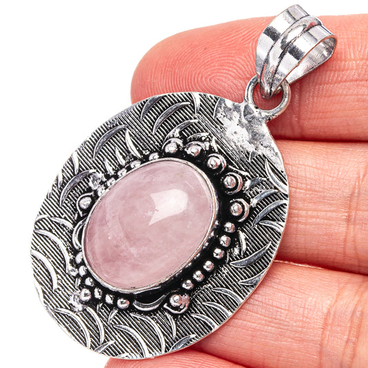 Rose quartz cabochon pendant in ornate German silver oval bezel, with loop bail