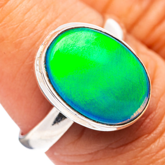 Sterling silver opal ring with oval green-blue cabochon gemstone bezel