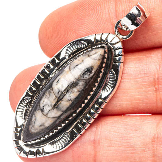 Oval orthoceras fossil pendant with .925 sterling silver bail, set in textured engraved border