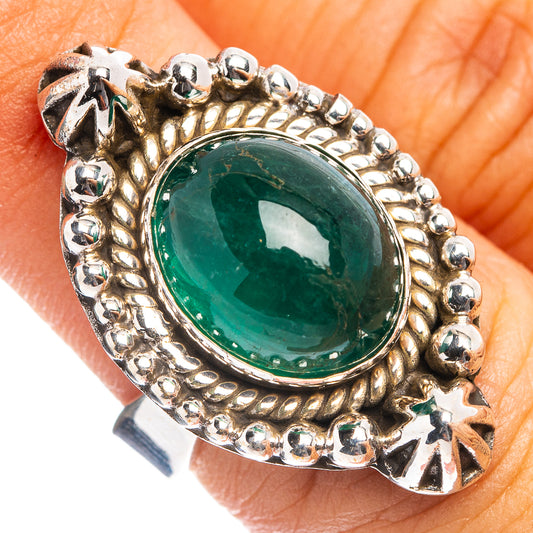 Green oval emerald cabochon ring with beaded halo on silver adjustable band