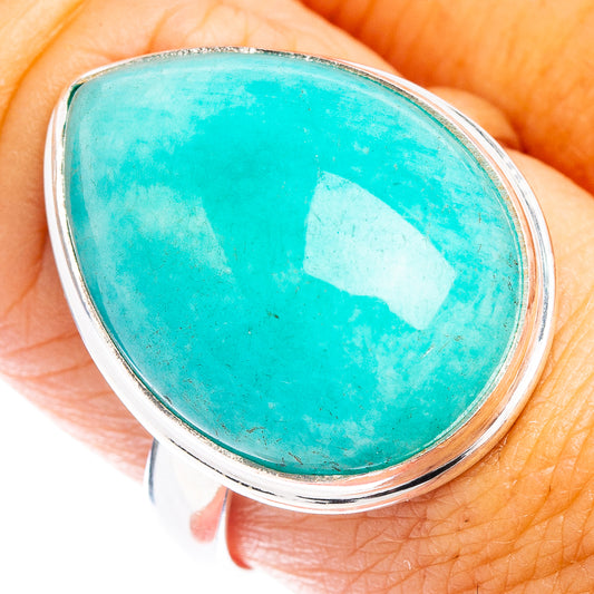 Sterling silver ring with oval turquoise gemstone cabochon, close-up on finger