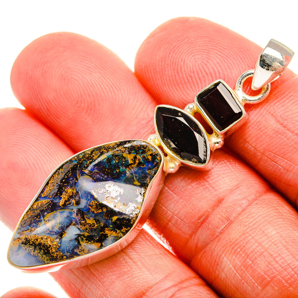Sterling silver pendant: teardrop boulder opal with red and dark bezel stones