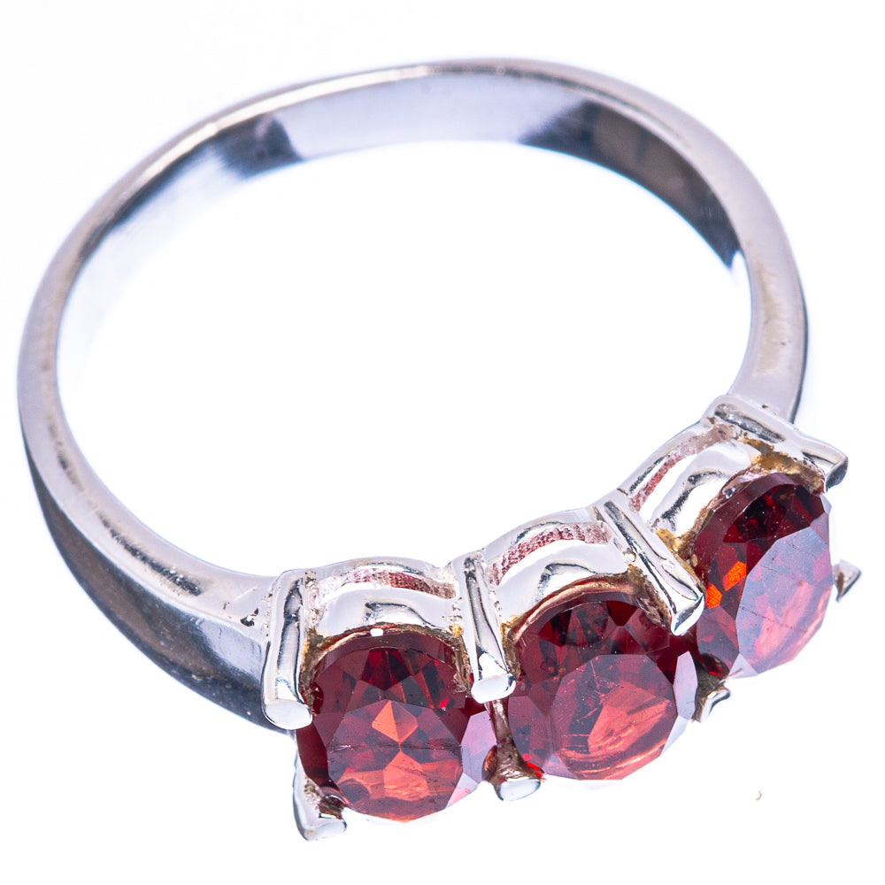 Garnet ring with three red gemstones in openwork prong setting on sterling band