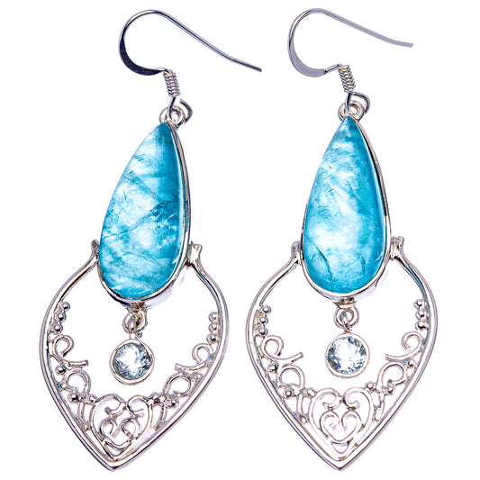 Sterling silver earrings with blue teardrop stones and ornate heart filigree