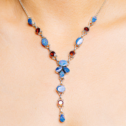 Sterling silver necklace with blue opal doublet stones and red garnet accents
