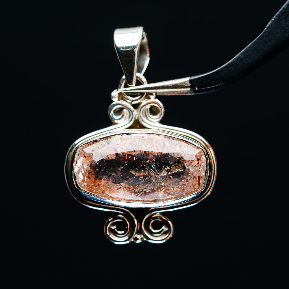 Faceted orange lepidocrocite oval pendant in .925 sterling silver with ornate bail