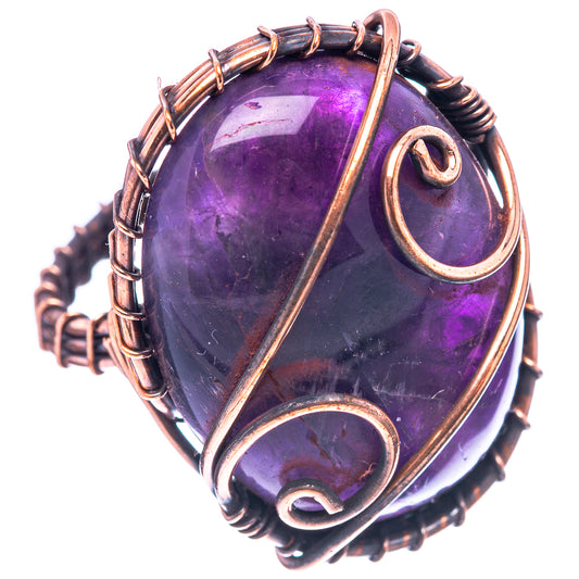 Amethyst wire-wrapped ring with purple oval gemstone and oxidized copper bezel detail