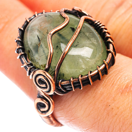 Prehnite wire wrap ring with oval green stone, oxidized copper swirl frame