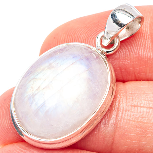 Oval pink opal gemstone pendant with .925 sterling silver bezel and bail on finger.