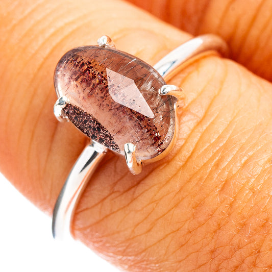 Faceted cacoxenite ring with oval pink-brown stone and sterling silver prongs
