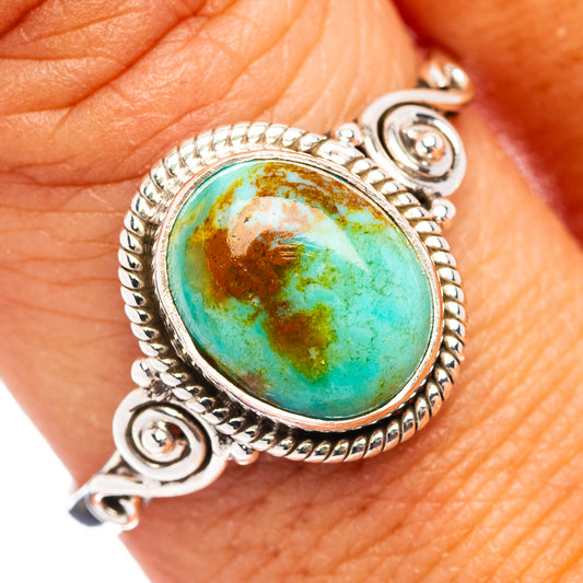 Sterling silver turquoise cabochon ring with ornate rope bezel and side scrolls