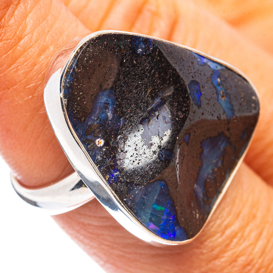 Sterling silver boulder opal ring with curved dark blue teardrop stone and flashes
