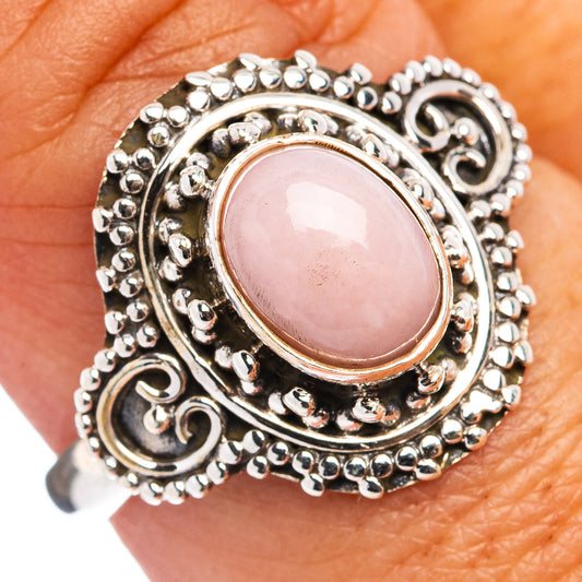 Sterling silver opal-style oval ring with pink center stone and ornate scalloped filigree