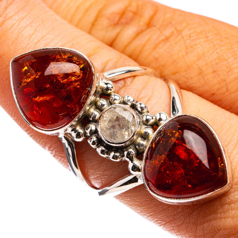 Sterling silver amber ring with two teardrop amber stones and a round moonstone center