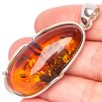 925 sterling silver oval Baltic amber pendant with curved bezel and loop bail