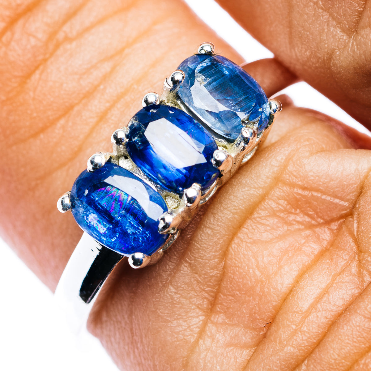 Three-stone kyanite ring, oval blue gems in sterling silver prongs