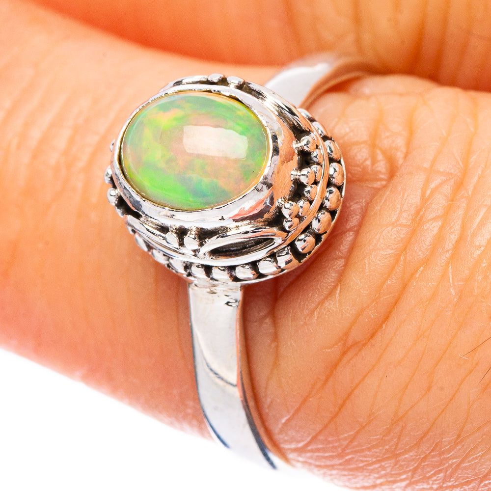 Oval opal ring in sterling silver with detailed bezel and side engravings