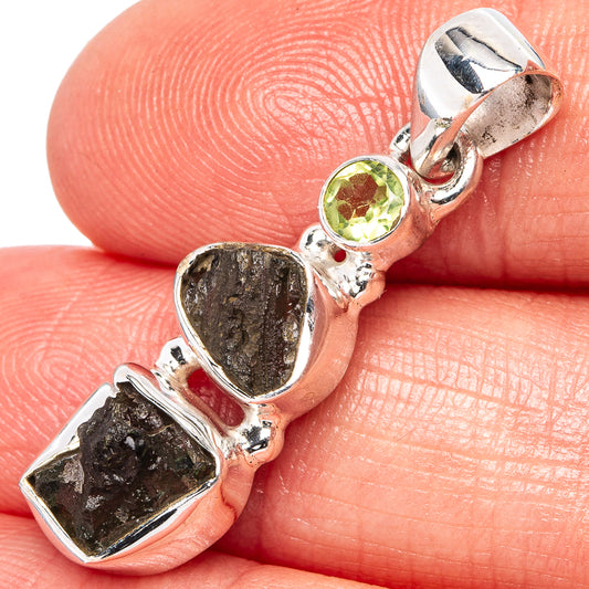 Sterling silver pendant with round peridot and rough moldavite stones in bezel setting