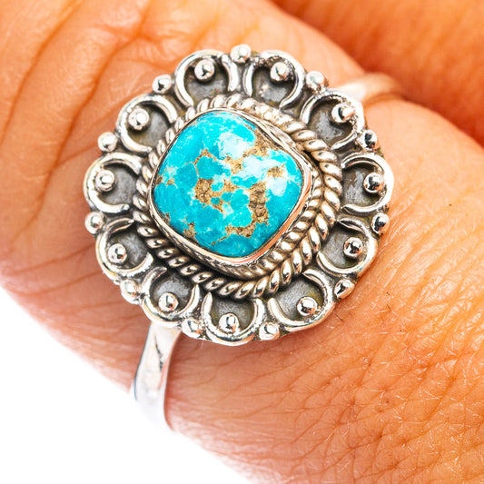 Turquoise cabochon dainty ring with ornate silver bezel, close-up top view
