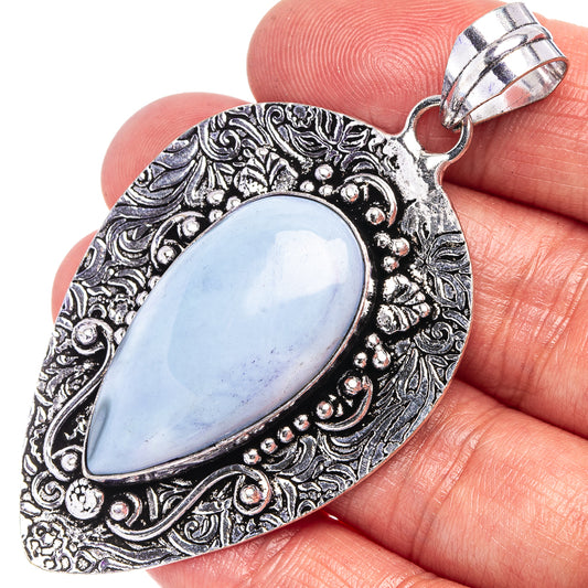 German silver opal pendant with blue oval stone and ornate engraved border