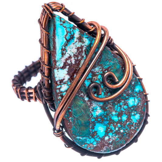 Turquoise speckled cabochon ring in oxidized copper, angled view with wire wrap