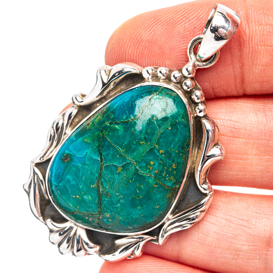 Oval chrysocolla pendant with ornate .925 sterling silver bezel and silver bail loop