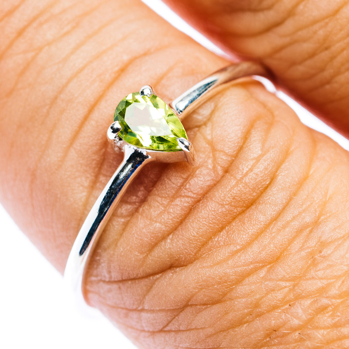 Sterling silver stackable ring with oval peridot gemstone and four prongs
